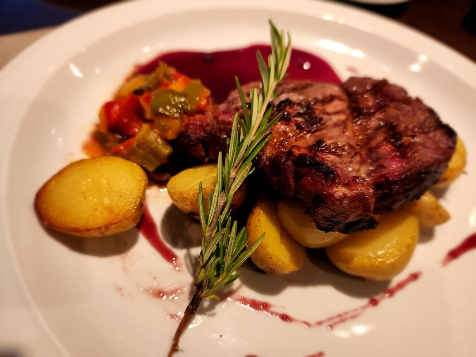 Regal Pacific Puerto Madero Hotel Buenos Aires Kültér fotó A steak prepared with a sprig of rosemary